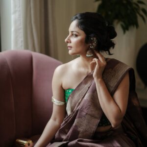Woman wearing everyday artificial jewellery from The Lakshury – stud earrings, chain necklace, and bracelets
